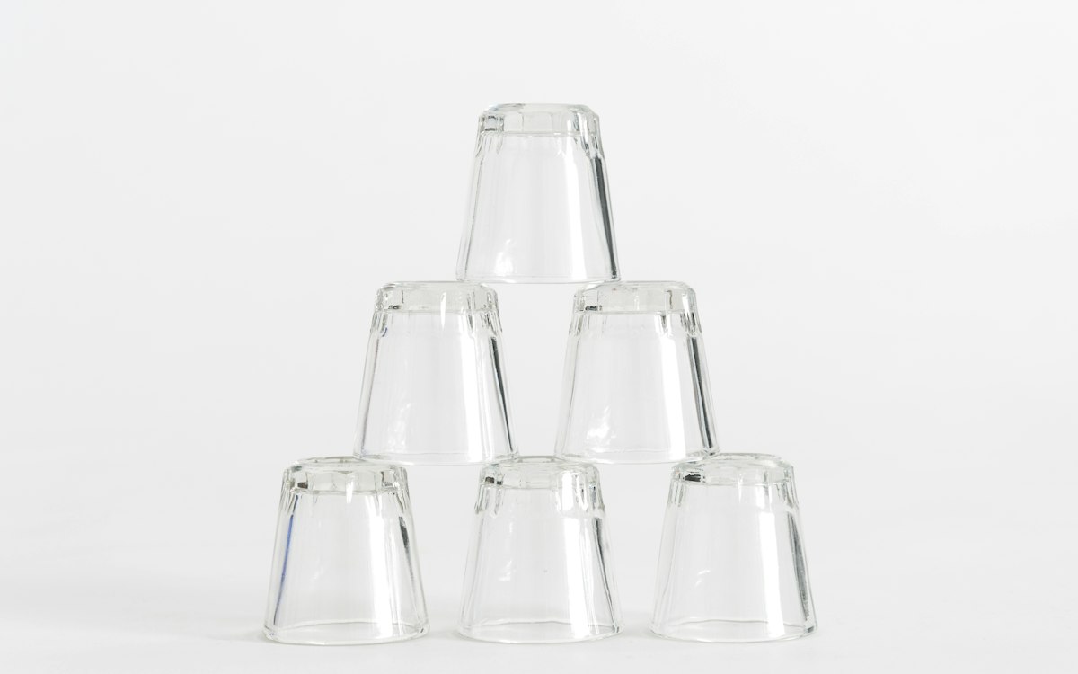 Six drinking glasses stacked into a pyramid