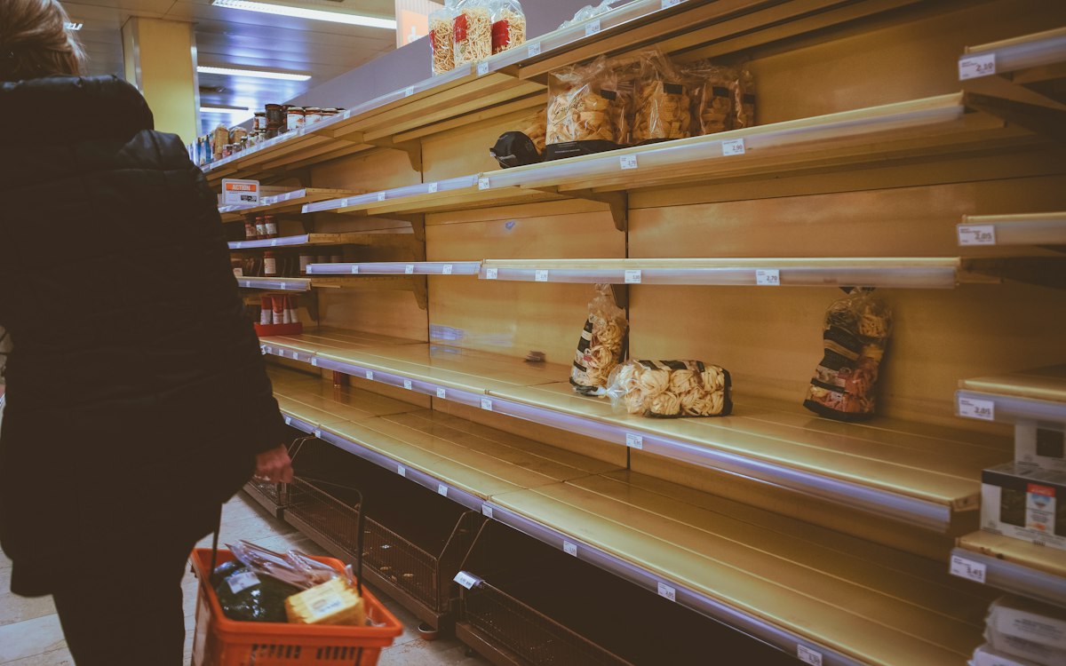 Supermarket aisle with mostly empty shelves