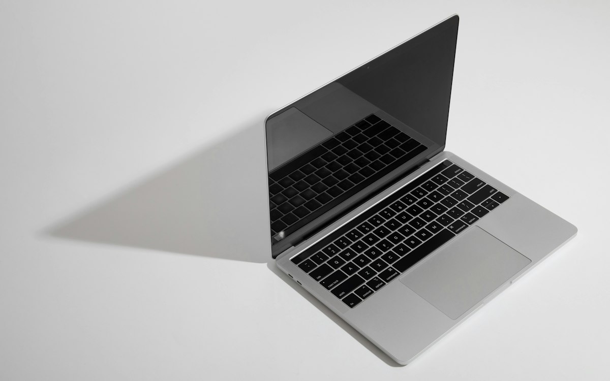 Open laptop on a plain white surface
